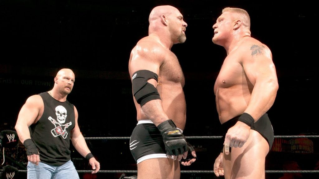 Goldberg (C) faces off against Brock Lesnar with Stone Cold Steve Austin (L) watching at WWE WrestleMania 20.