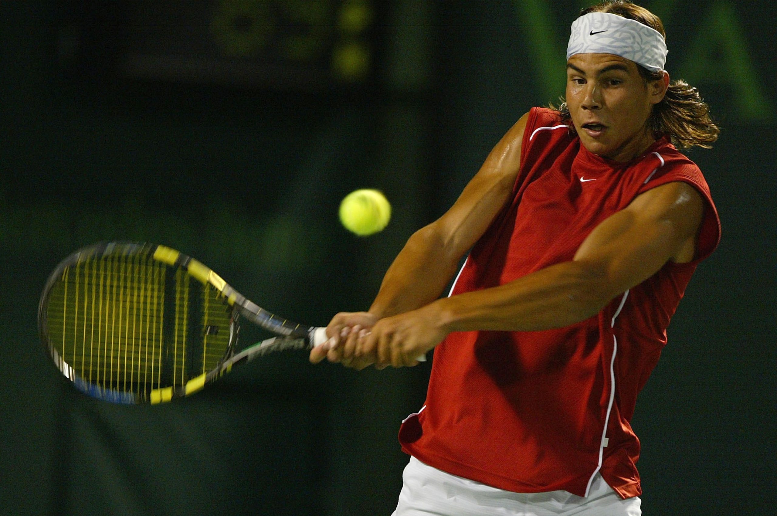 Rafael Nadal of Spain plays a backhand against Roger Federer of Switzerland during the third round of Nasdaq 100 Open on March 28, 2004, in Miami, Florida.