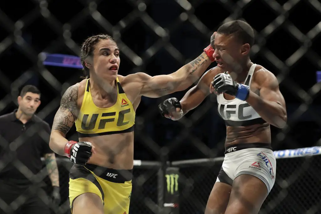 Jessica Andrade (yellow) of Brazil hits Angela Hill with a left hook during their women's strawweight bout at UFC Fight Night.