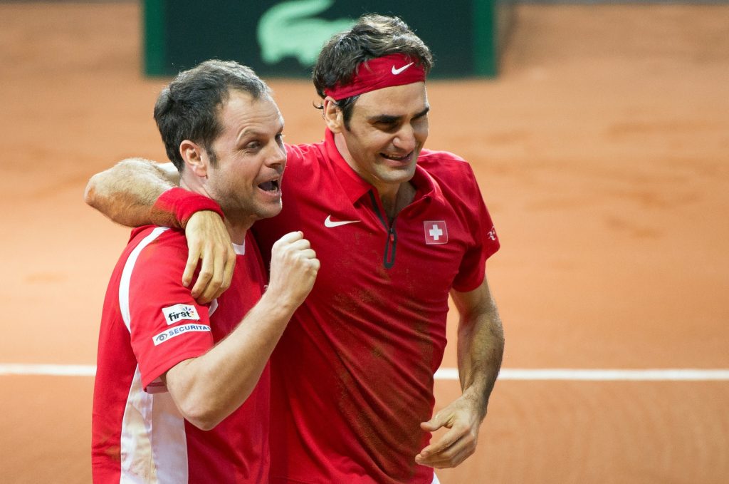 Roger Federer celebrates with Switzerland's Davis Cup team captain Severin Luthi after beating France's Richard Gasquet in their tennis match at the Davis Cup final in 2014.