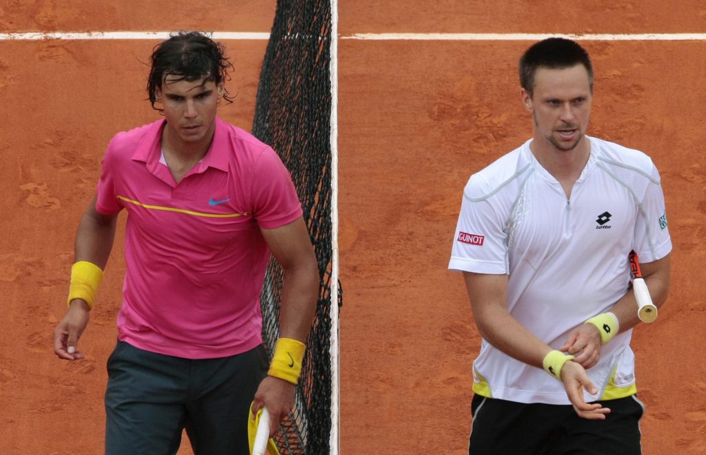 Spanish player Rafael Nadal (left) leaves the court after his fourth round loss to Swede Robin Soderling at the 2009 French Open.