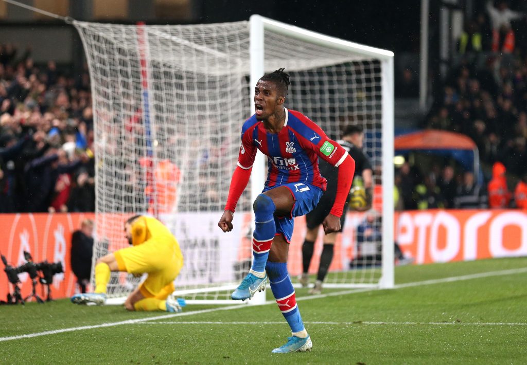 Wilfried Zaha celebrates after scoring a goal against Brighton in the Premier League (Getty Images)