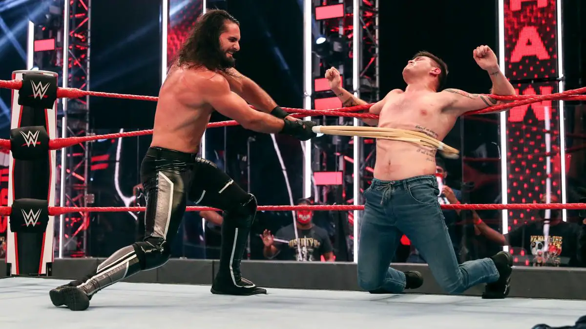 Seth Rollins attacks Dominik Mysterio with a kendo stick