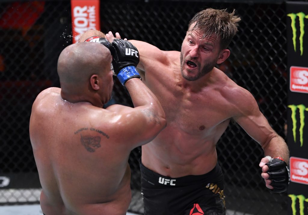 Stipe Miocic (R) punches Daniel Cormier in their UFC heavyweight championship bout during the UFC 252 event.