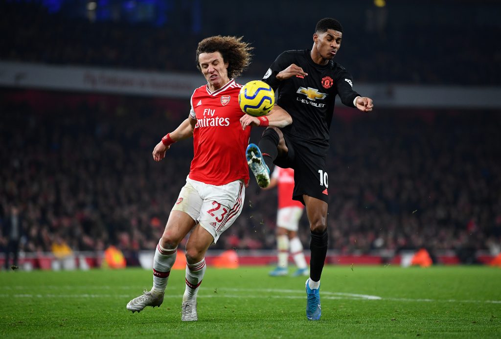 David Luiz of Arsenal takes on Marcus Rashford of Manchester United