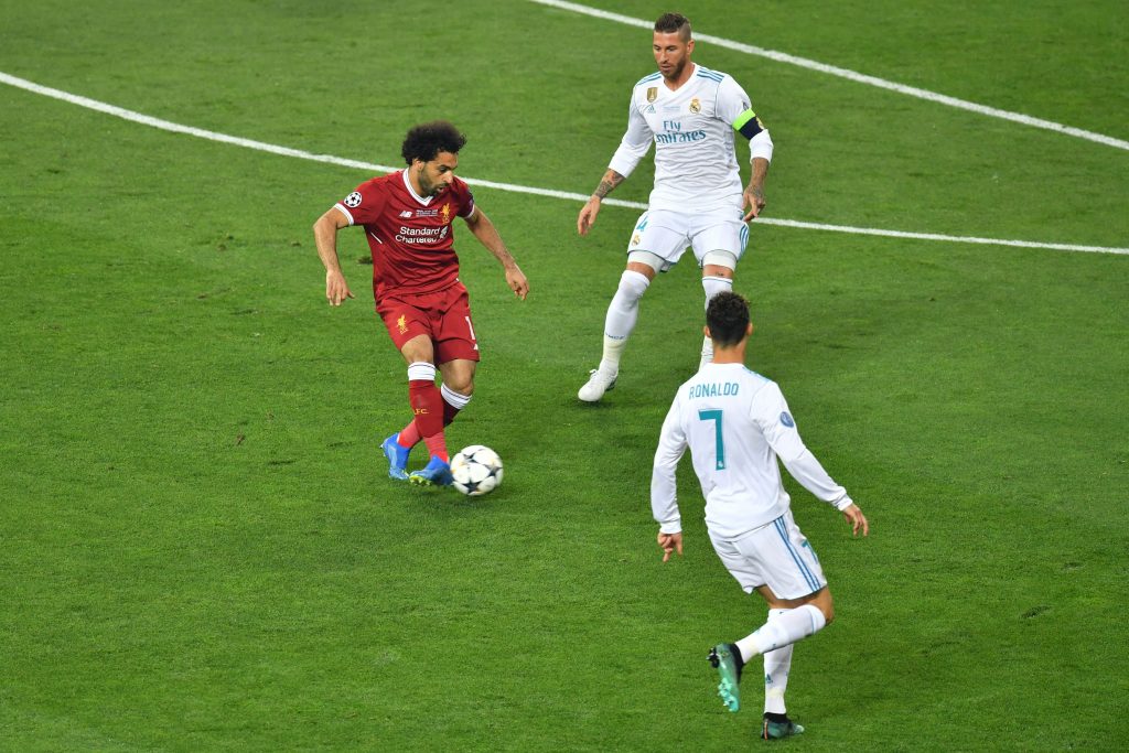 Liverpool's Egyptian forward Mohamed Salah (L), Real Madrid's Spanish defender Sergio Ramos (C) and Real Madrid's Portuguese forward Cristiano Ronaldo (R) vie for the ball during the UEFA Champions League final football match between Liverpool and Real Madrid at the Olympic Stadium in Kiev, Ukraine on May 26, 2018. (Photo by Sergei SUPINSKY / AFP) (Photo credit should read SERGEI SUPINSKY/AFP via Getty Images)