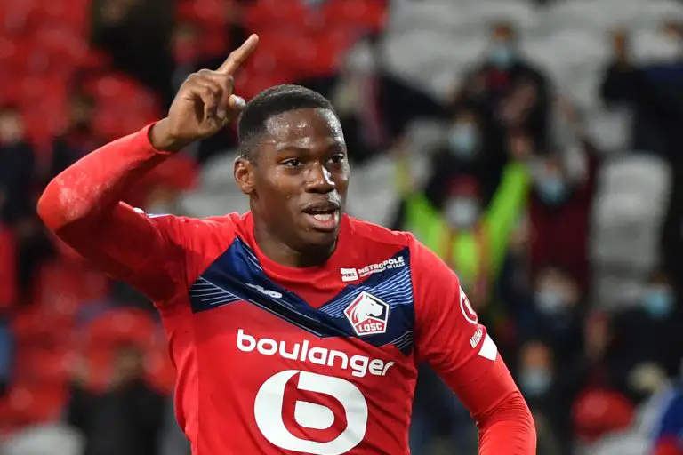 Lille's Canadian forward Jonathan David celebrates after Nantes scored an own goal during a French L1 football match. (Photo by DENIS CHARLET/AFP via Getty Images)