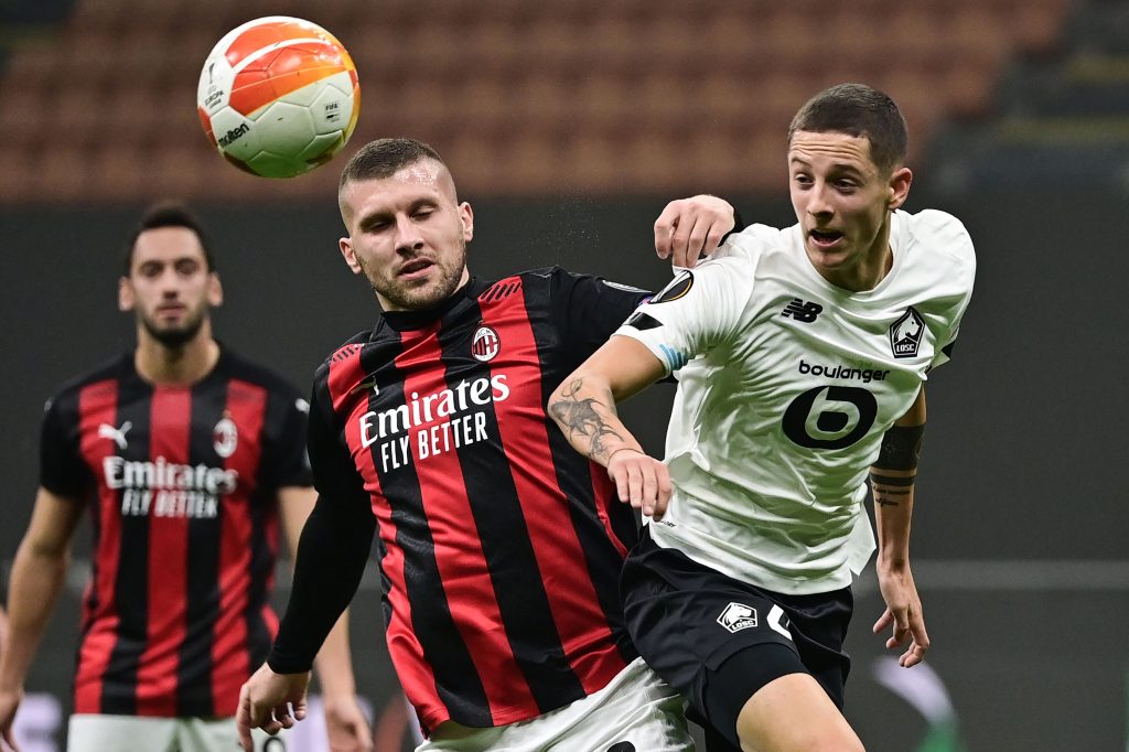 AC Milan's Croatian forward Ante Rebic (L) fights for the ball with Lille's Dutch defender Sven Botman.