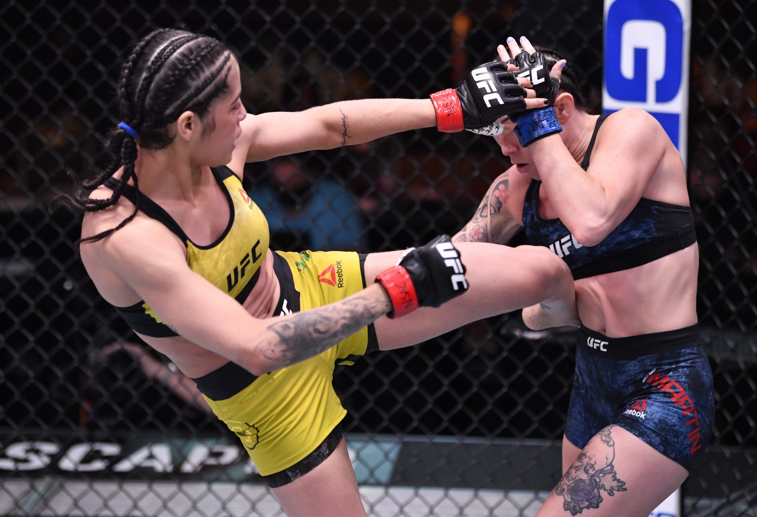 Polyana Viana of Brazil kicks Mallory Martin in their strawweight fight dur...