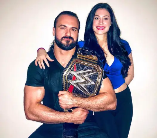 Drew McIntyre with his wife, Kaitlyn, and the WWE heavyweight championship.)