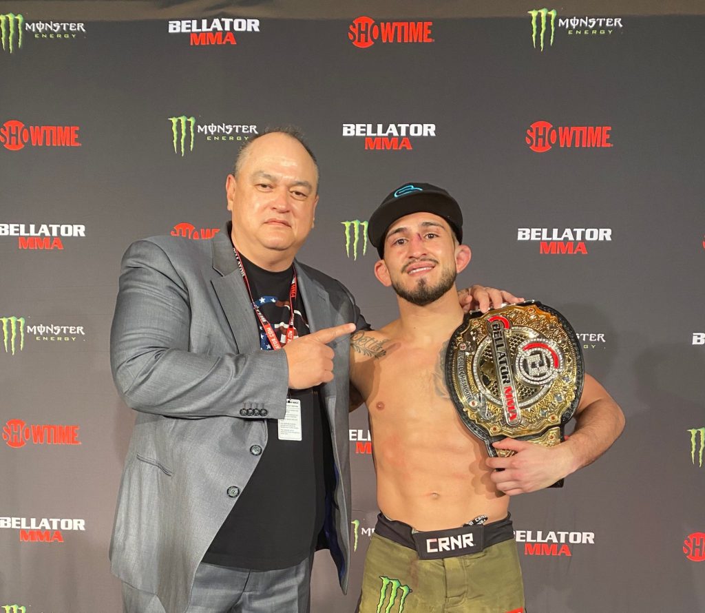 Sergio Pettis with the Bellator Bantamweight title alongside Bellator CEO Scott Coker