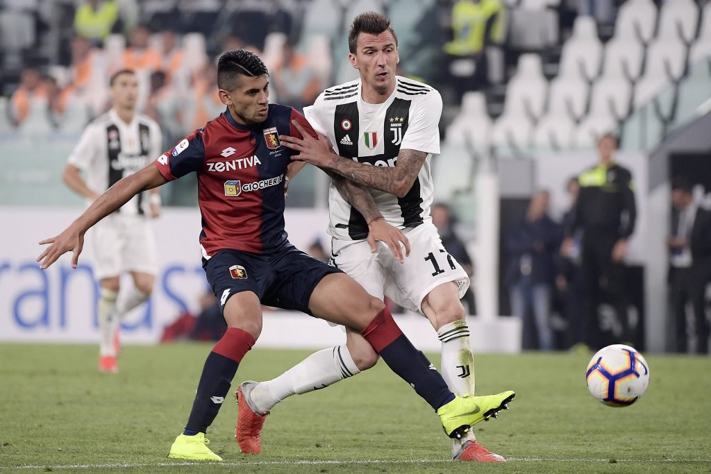 Christian Romero in action during a Serie A match against Juventus.