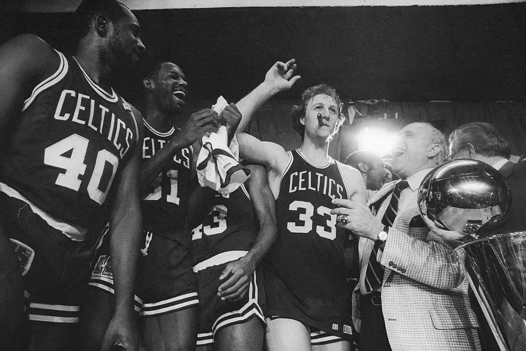 Boston Celtics general manager Red Auerbach laughs after Larry Bird stole his cigar during a victory celebration after the Celtics beat the Houston Rockets to win the NBA championship.